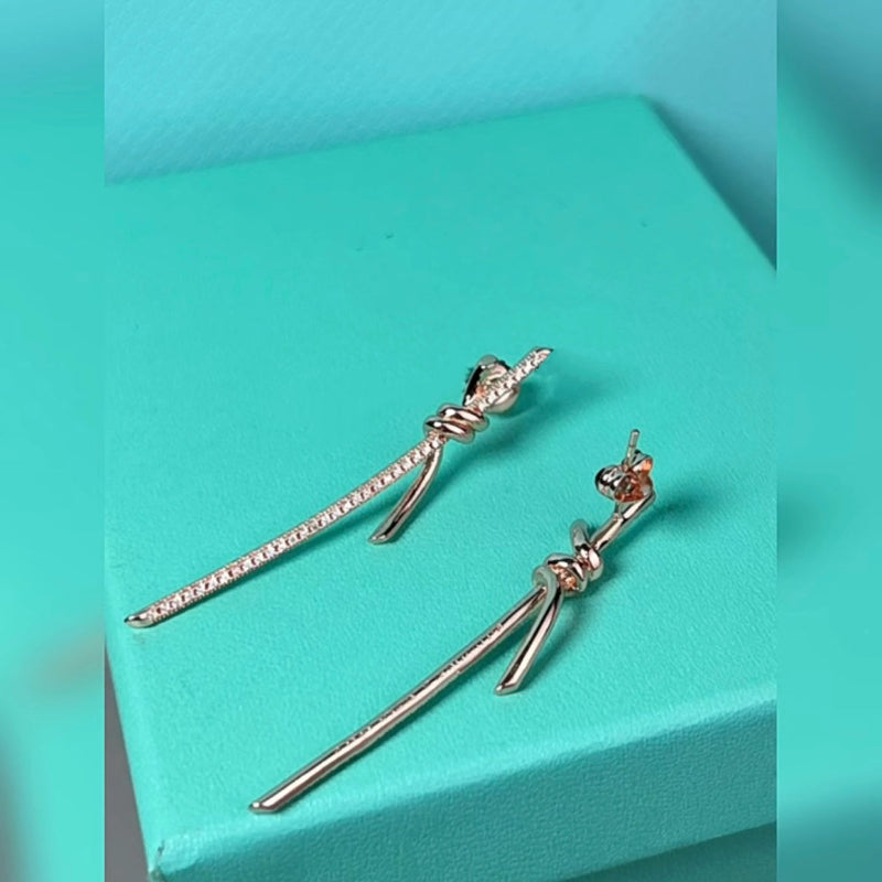 white gold knot style drop earrings with crystal pave