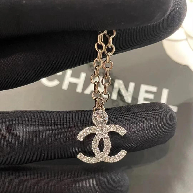 close up of full crystal CC pendant with top solitaire crystal on 23K necklace
