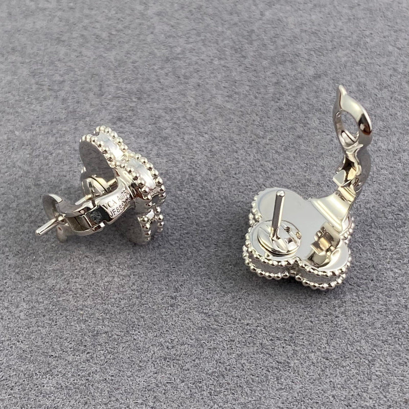 close up of four leaf clover motif with gold bead contour on white gold earrings