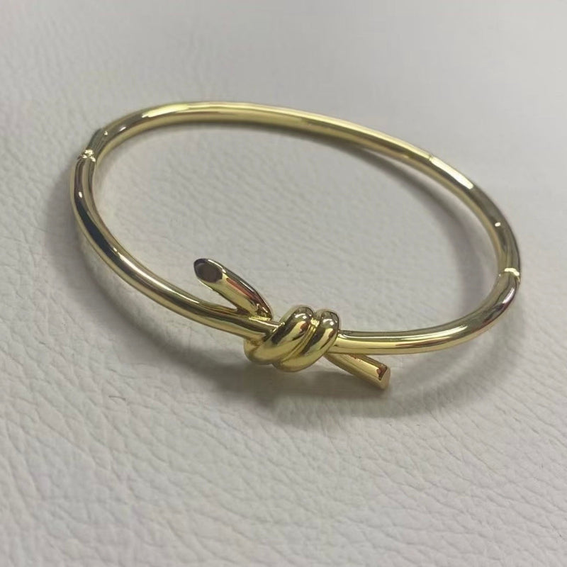 yellow gold knot style wire bangle