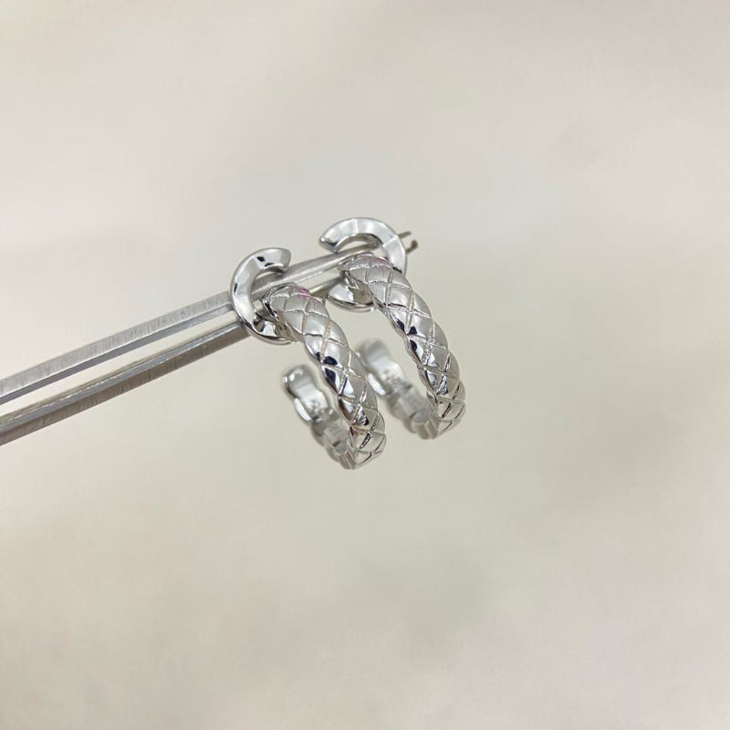 close up of CC COCO letter hoop earrings with diamond quilted texture