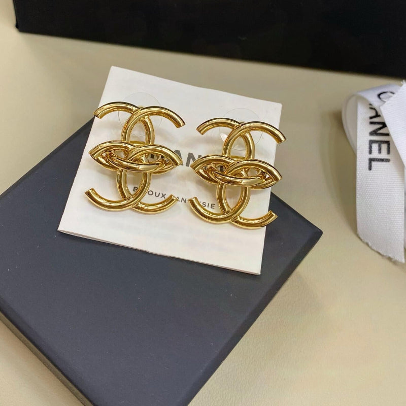 close up of interlocking CC logo stud earrings gold tone large size