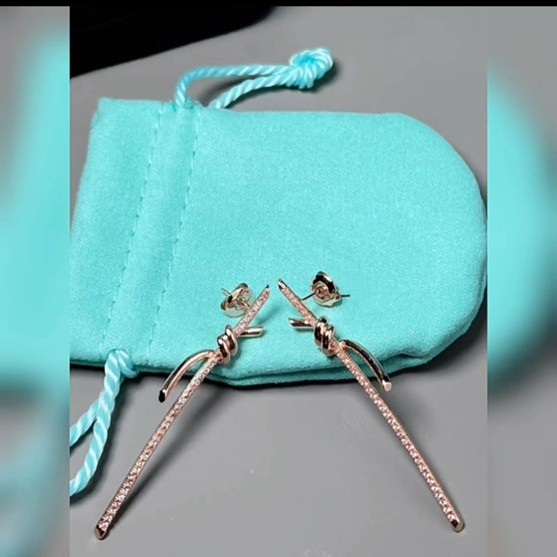 rose gold knot style drop earrings with crystal pave