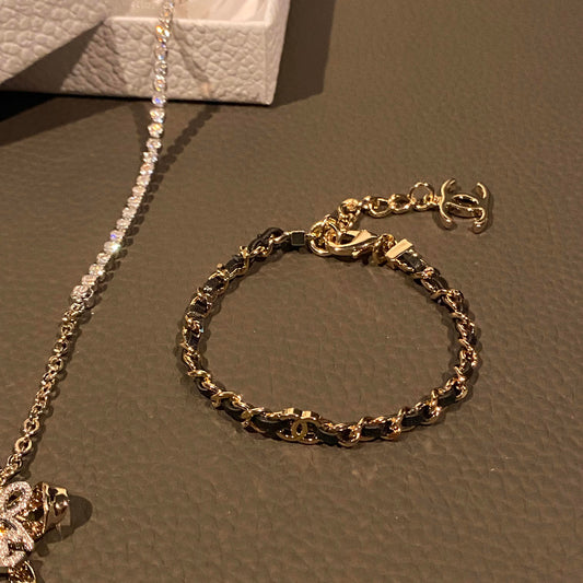 26P style CC black leather woven chain bracelet on white background