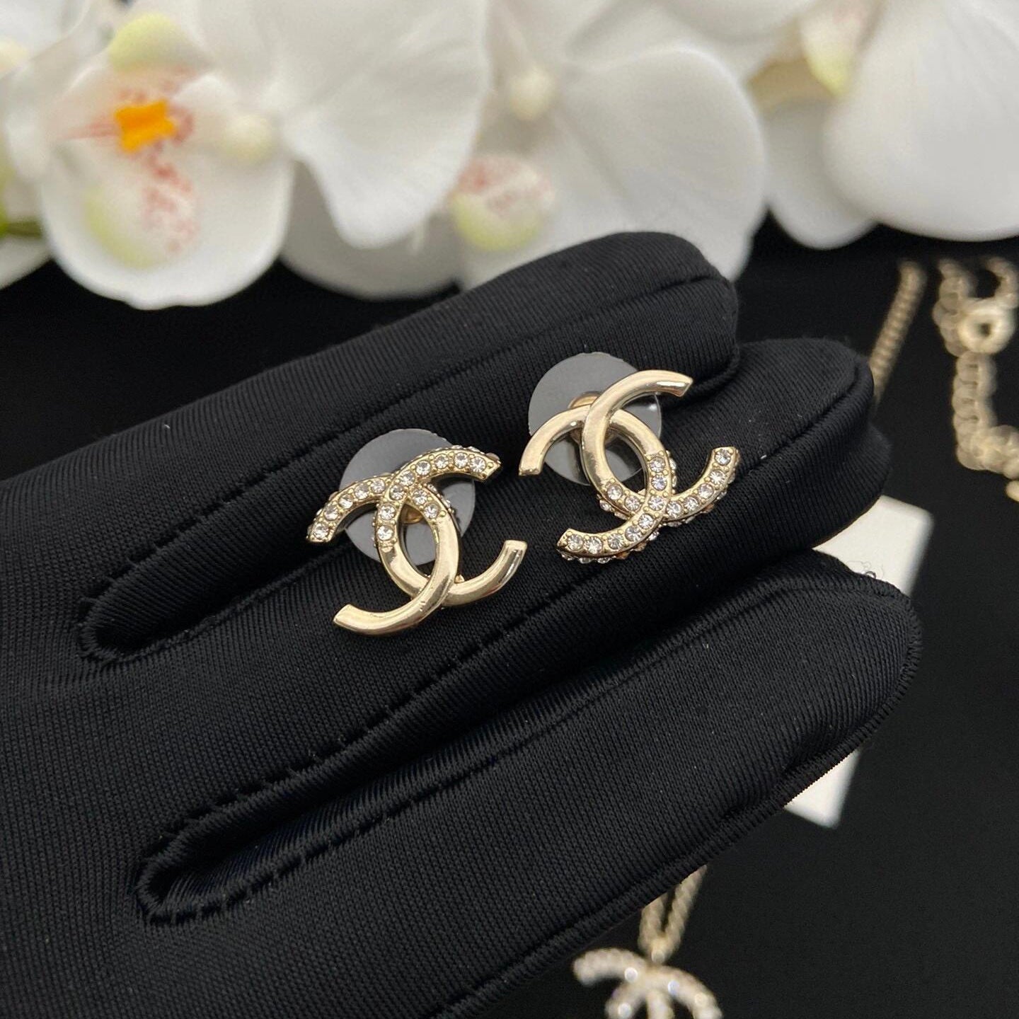 close up of half diamond CC stud with asymmetric crystal pave and metal finish