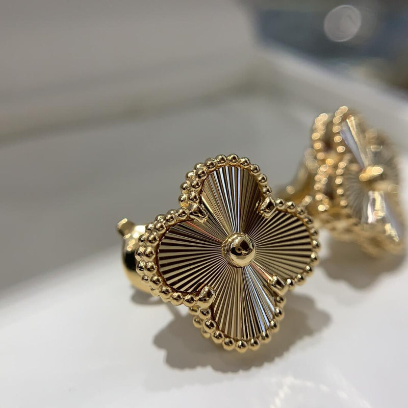 close up of sunburst guilloché engraved pattern on four leaf clover motif with gold bead contour
