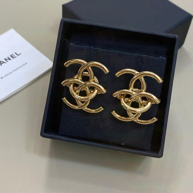 close up of interlocking CC logo stud earrings gold tone large size