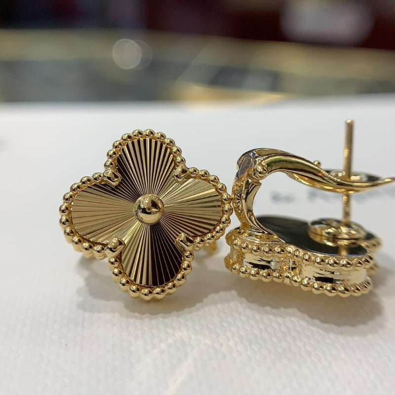 close up of sunburst guilloché engraved pattern on four leaf clover motif with gold bead contour