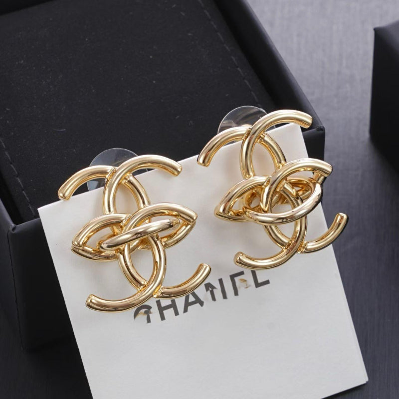 close up of interlocking CC logo stud earrings gold tone large size