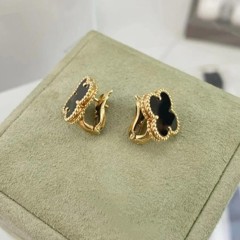 close up of black onyx four leaf clover motif with gold bead contour on yellow gold earrings