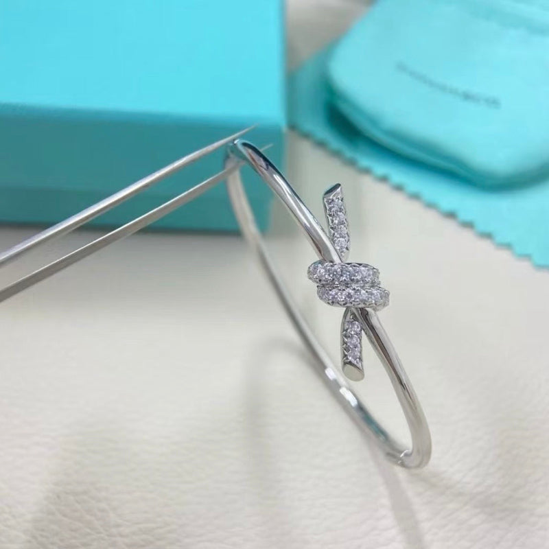 white gold knot style wire bangle with crystal pave hinged bracelet