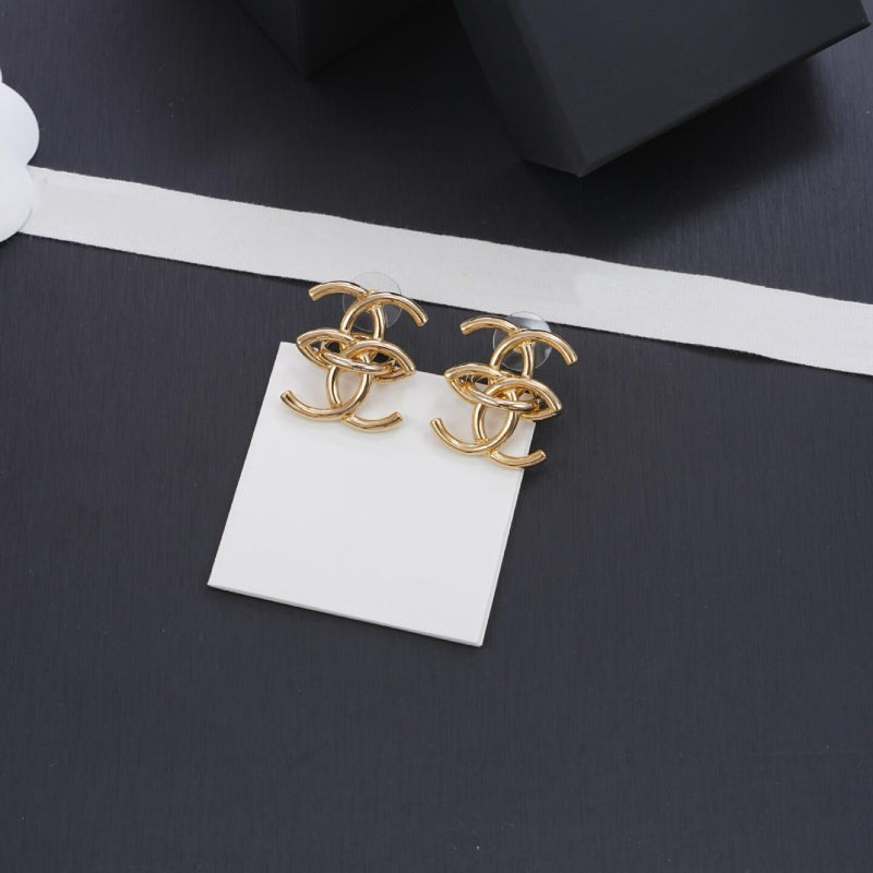 close up of interlocking CC logo stud earrings gold tone small size