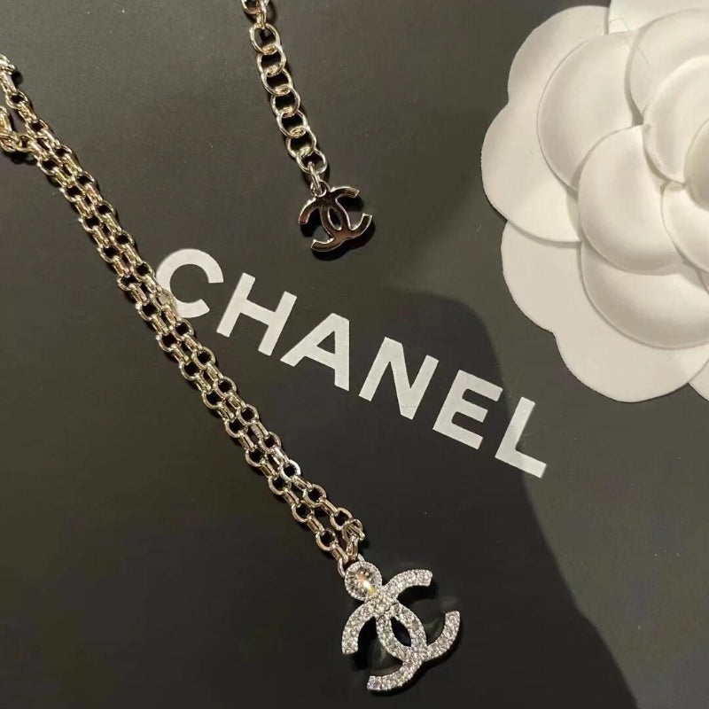 close up of full crystal CC pendant with top solitaire crystal on 23K necklace