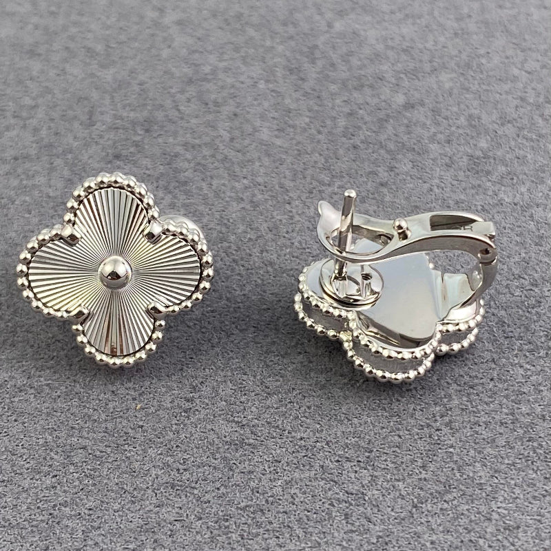 close up of four leaf clover motif with gold bead contour on white gold earrings