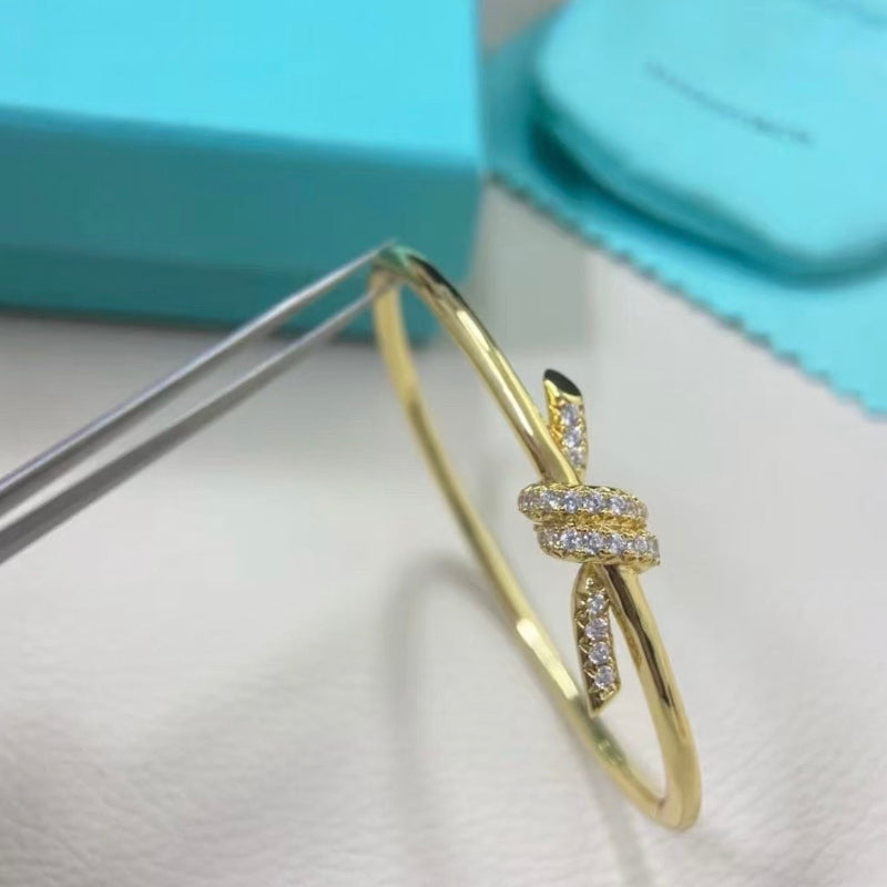 yellow gold knot style wire bangle with crystal pave hinged bracelet