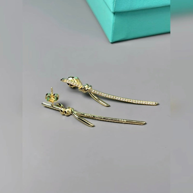 yellow gold knot style drop earrings with crystal pave