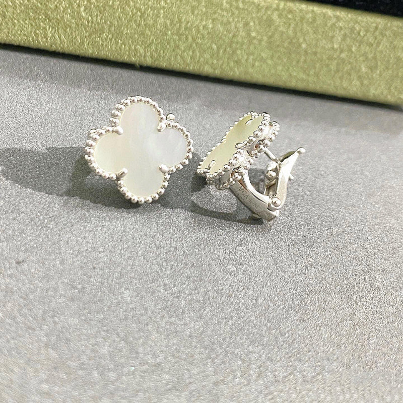 close up of iridescent white mother of pearl four leaf clover motif with gold bead contour on white gold earrings