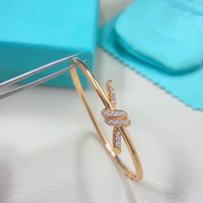 rose gold knot style wire bangle with crystal pave hinged bracelet