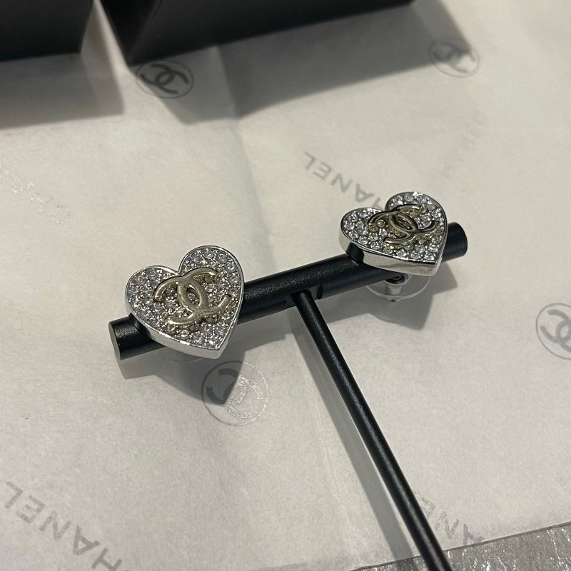 close up of full crystal pave heart earrings with champagne gold CC logo
