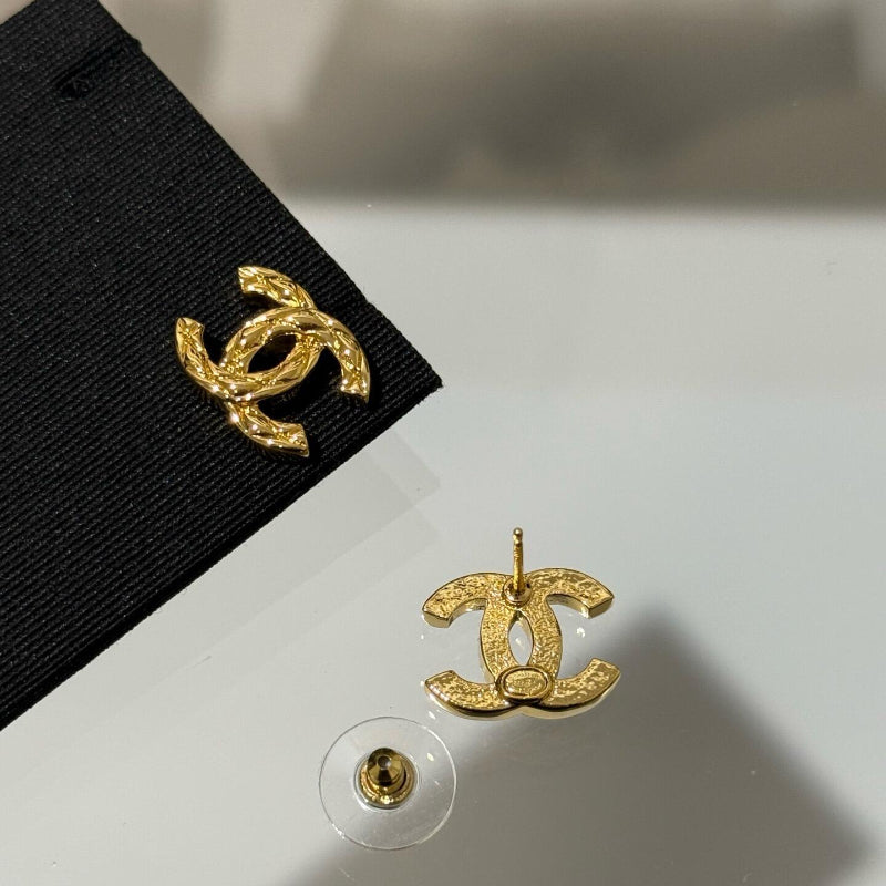 close up of quilted pattern on CC logo gold plated earrings