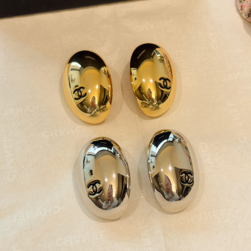 26S oval CC gold plated earrings on white background
