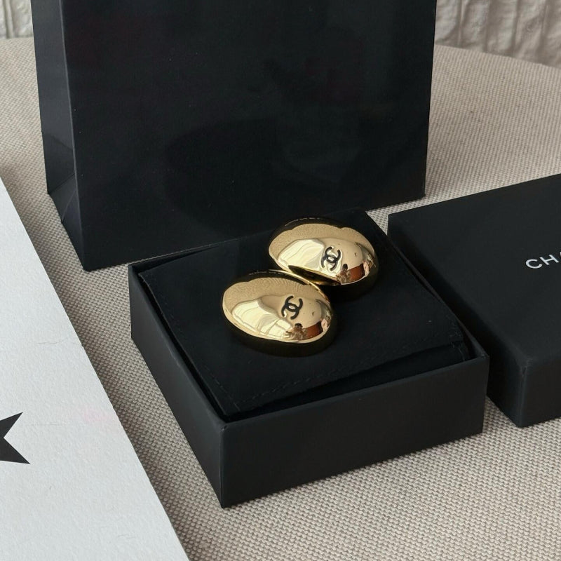 close up of quilted egg-shape pattern on CC logo stud earrings Yellow gold