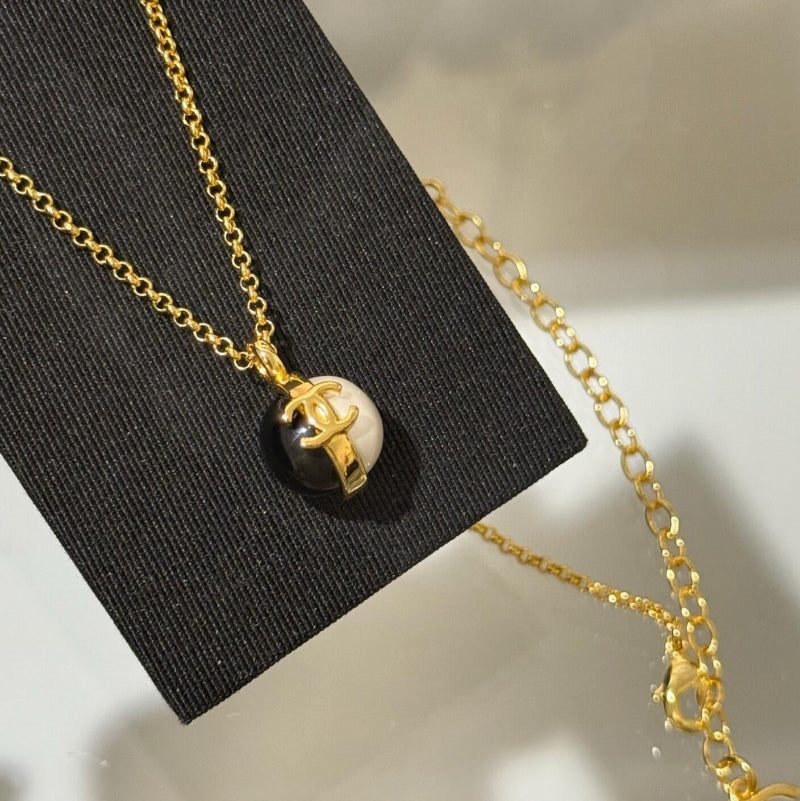 26P style CC black and white ball pendant necklace on white background
