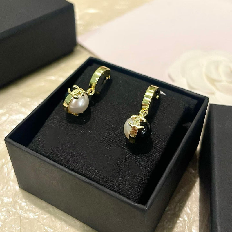 26P style CC black and white ball drop earrings on white background