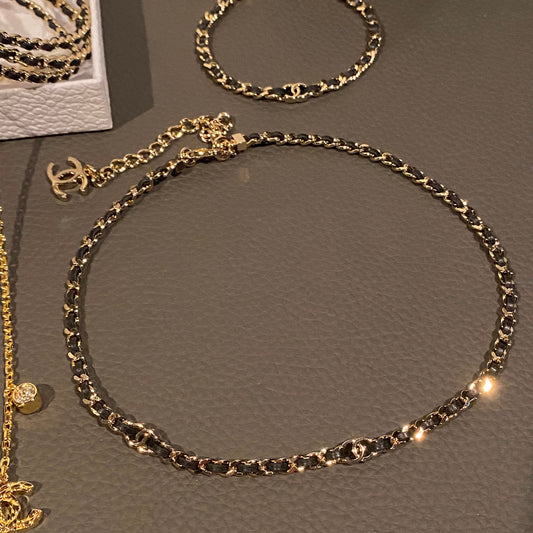 26P style CC black leather woven chain necklace on white background