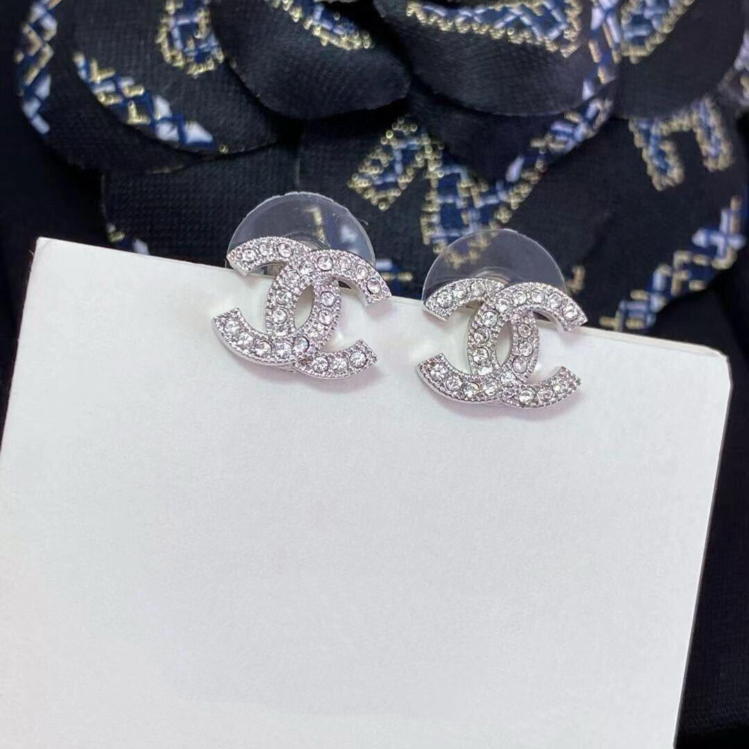 close up of crystal pave CC logo stud earrings 18K gold