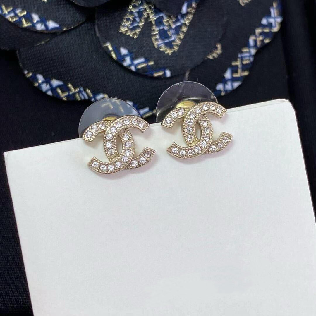 close up of crystal pave CC logo stud earrings 18K gold