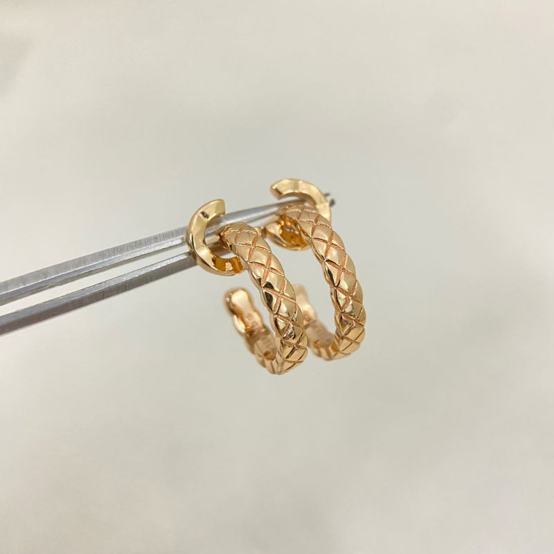close up of CC COCO letter hoop earrings with diamond quilted texture