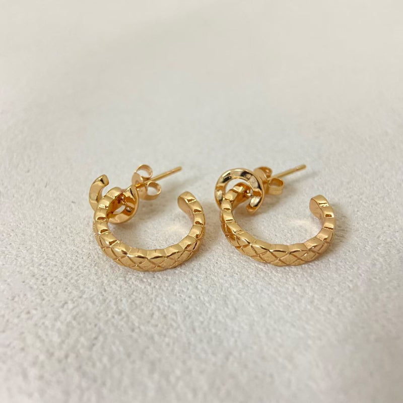 close up of CC COCO letter hoop earrings with diamond quilted texture