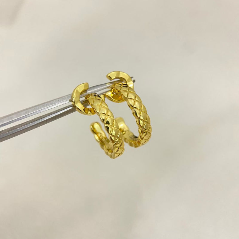 close up of CC COCO letter hoop earrings with diamond quilted texture