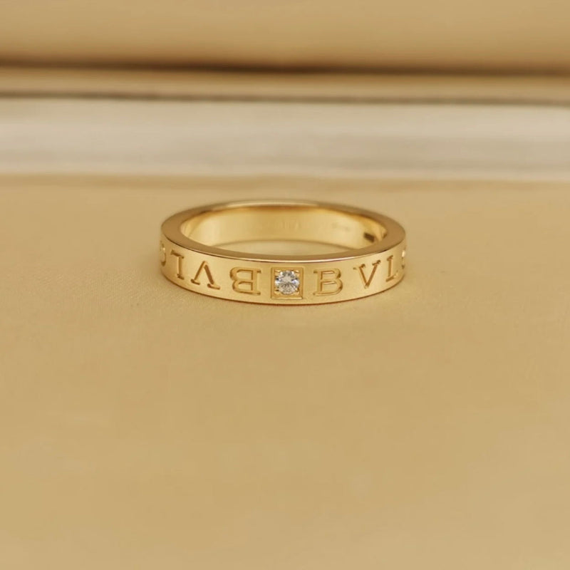 close up of yellow gold B.zero1 style ring with single crystal stone spiral design